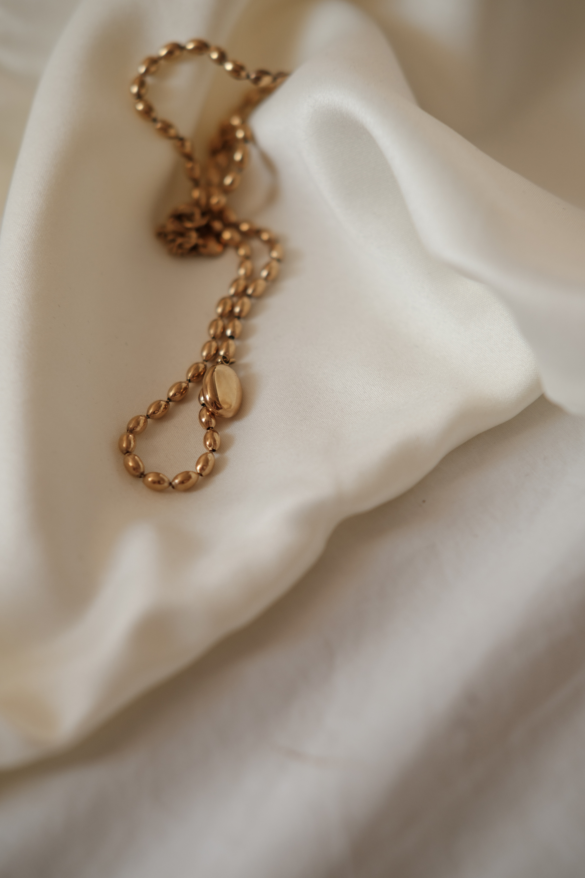 Gold Jewelry on White Silk Cloth